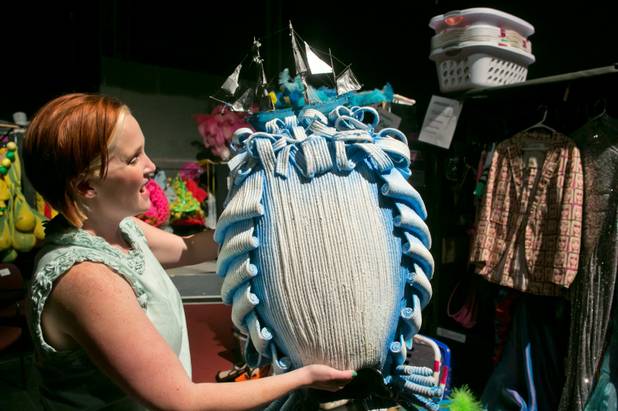 Gillian Austin, wardrobe supervisor for the new "Priscilla Queen of the Desert" show, holds up an intricate "Ship" head-dress used in the show, as seen Thursday, June 20, 2013.